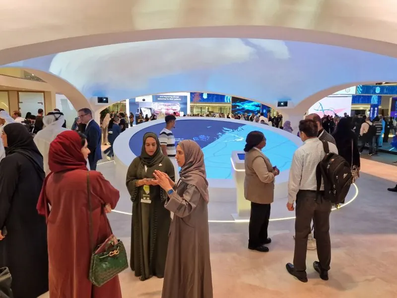 Delegates around an interactive display in an exhibition pavilion at WHX Dubai